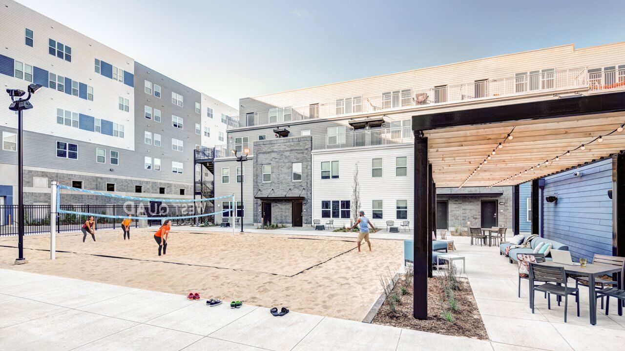 courtyard between apartment buildings with beach volleyball court