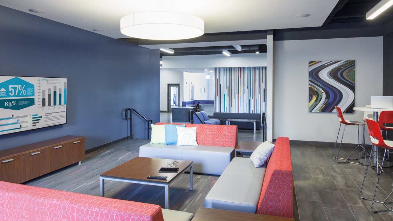 open shared space with sofas and round tables